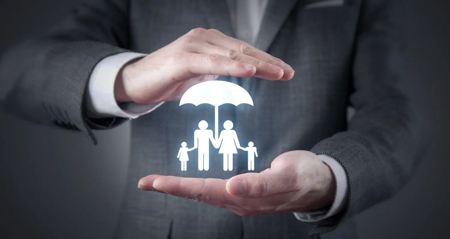 Hands sheltering a family under an umbrella